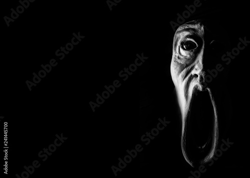 Фотография image of a panicked face screaming with bulging eyes, terrifying face