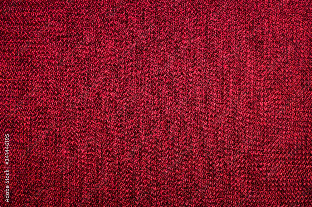 Fototapeta premium Textured background surface of textile upholstery furniture close-up. red Color fabric structure