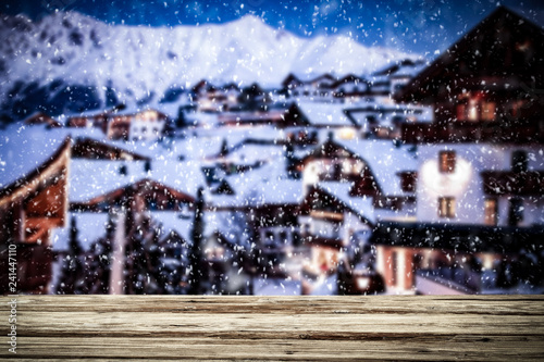 Old wooden table in the snowy mountains. Alps with a free place for an advertising product   © magdal3na