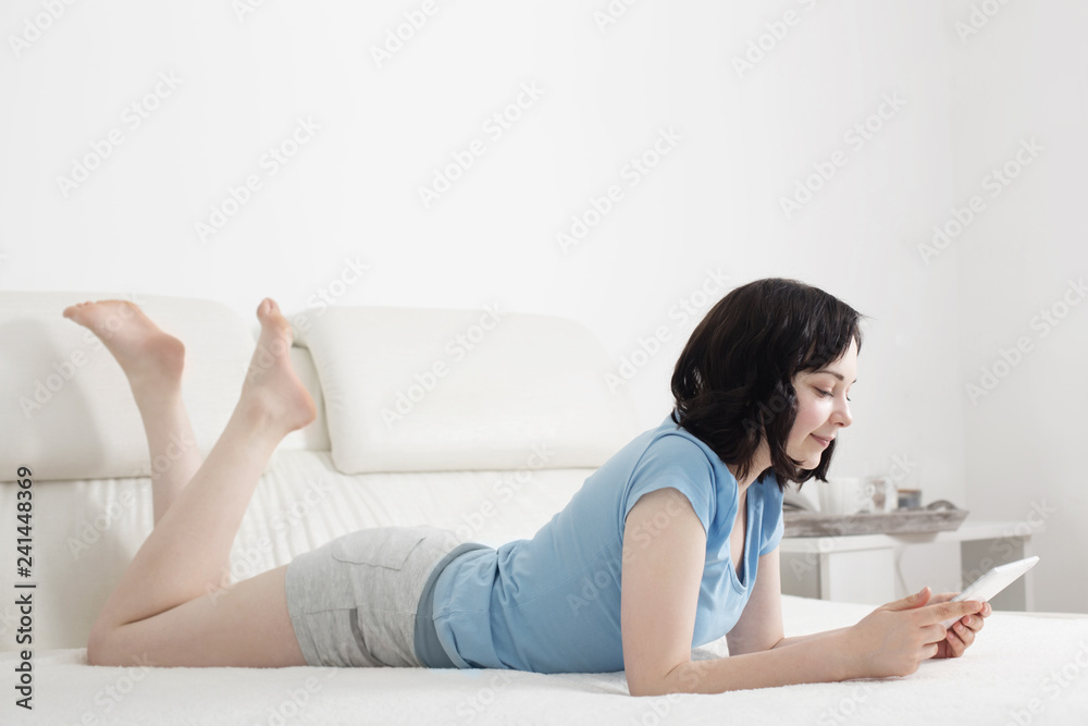 young girl in bedroom with tablet young girl in bedroom with tablet