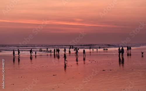 Silhouette of the people on Kuta Beach during sunset time in Bali Island, Indonesia
