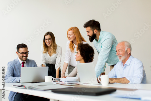 Joyful multiracial business team at work in modern office