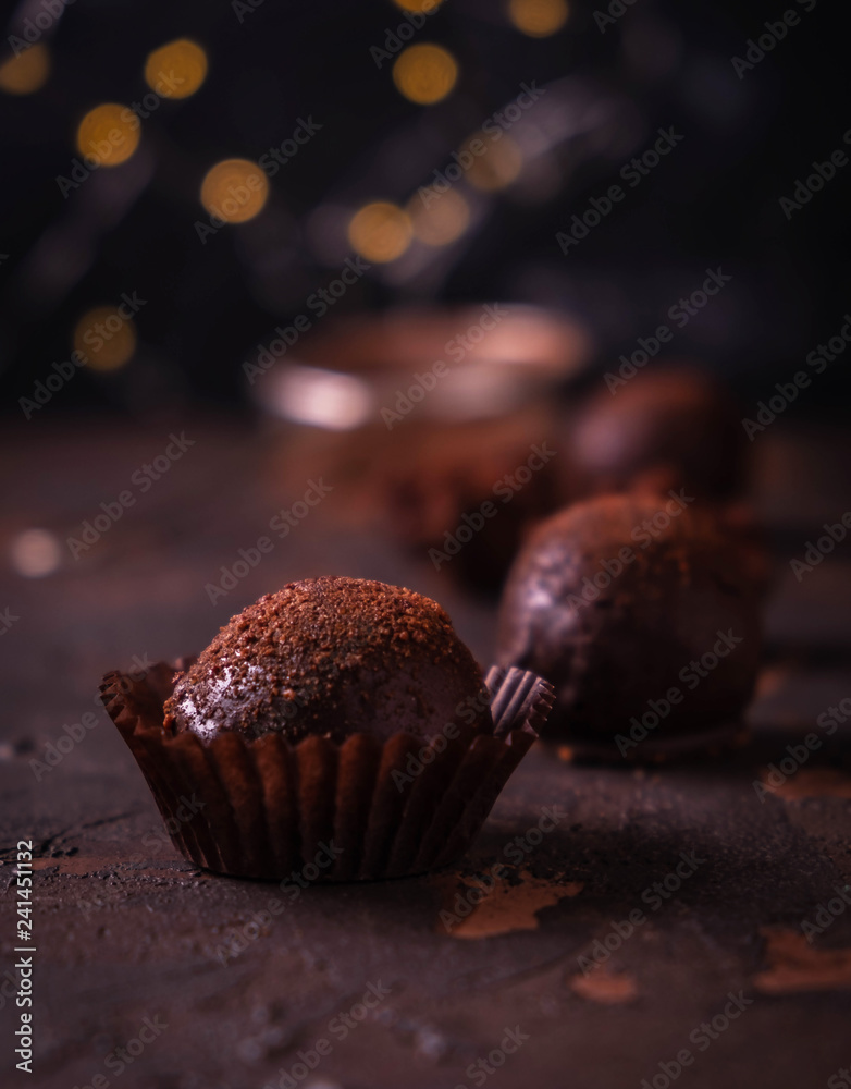 handmade chocolates on the table, brown background with bokeh effect handmade chocolates on the table, brown background with bokeh effect
