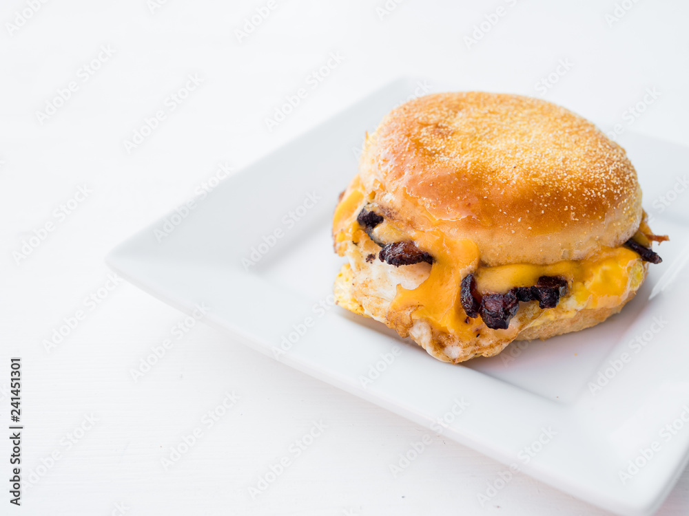 Classic breakfast sandwich on a gluten free english muffin. Bacon, egg, and cheese on bread and served for brunch. Classic breakfast sandwich on a gluten free english muffin. Bacon, egg, and cheese on bread and served for brunch.