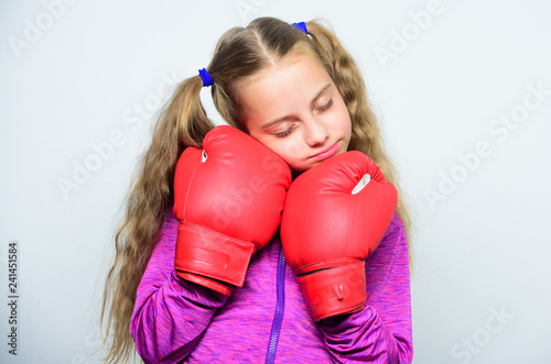 Girl cute child with red gloves posing on white background. Sport upbringing. Upbringing for leader. Strong child boxing. Sport and health concept. Boxing sport for female. Skill of successful leader