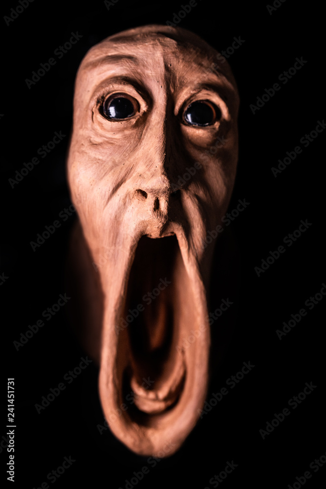 image of a panicked face screaming with bulging eyes, terrifying face. Face  of fear very frightened, concept of nightmare and scare. Image for  halloween or day of the dead фотография Stock |