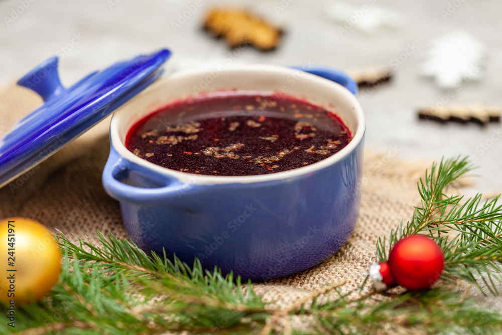 Christmas borscht in a pot with Christmas decorations in the background Christmas borscht in a pot with Christmas decorations in the background