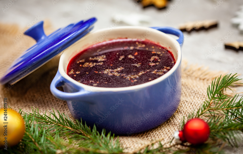 Christmas borscht in a pot with Christmas decorations in the background Christmas borscht in a pot with Christmas decorations in the background