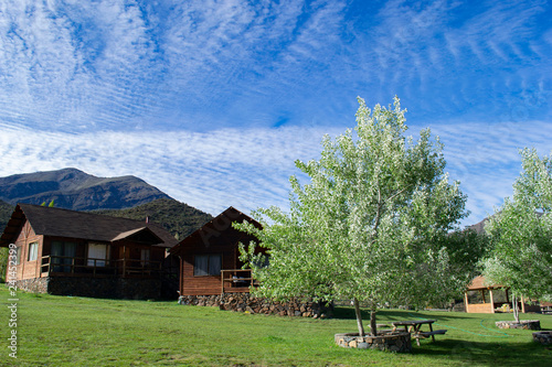 small hotel houses in the mountains. wooden. stand alone. against the backdrop of the mountains