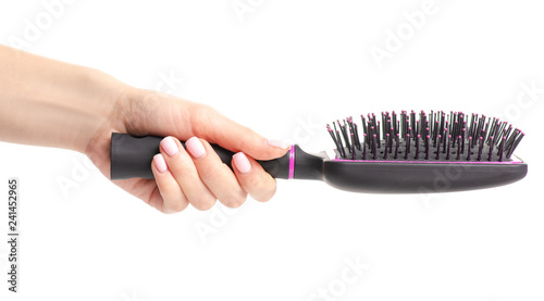 hairbrush comb female in hand on white background isolation