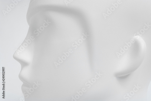 White plastic human head from mannequin as soft object with shadows, shades of gray, mild style concept
