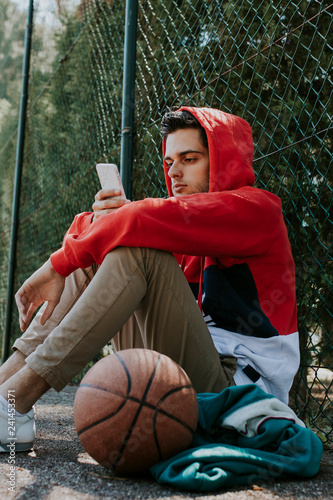 young athlete with outdoor mobile phone