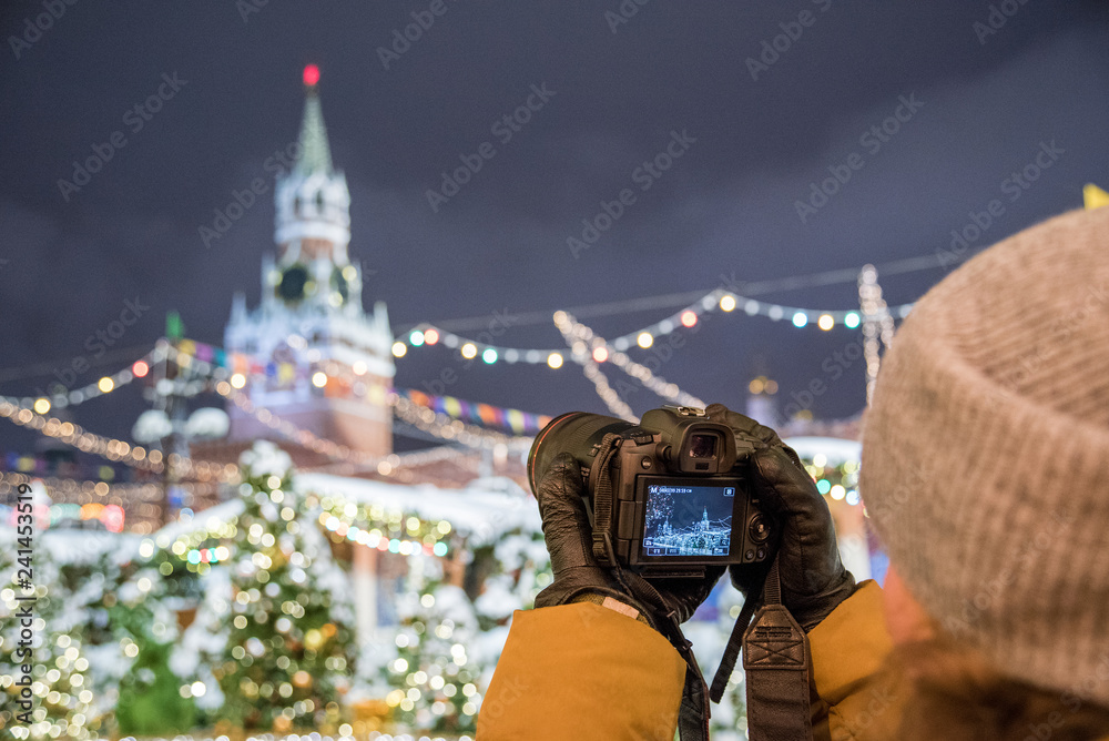 Obraz premium Red Square, Moscow, Russia - December 29, 2018: A photographer is shooting a new 30.1 megapixel full-frame mirrorless interchangeable-lens camera Canon EOS R