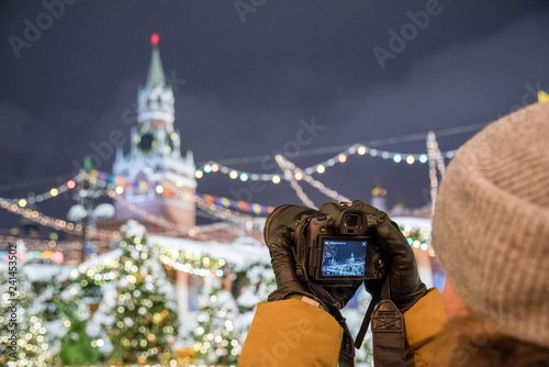 Red Square, Moscow, Russia - December 29, 2018: A photographer is shooting a new 30.1 megapixel full-frame mirrorless interchangeable-lens camera Canon EOS R photo