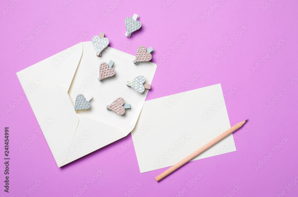 White Envelope on Purple Background and Heart Shaped Pins, Top View