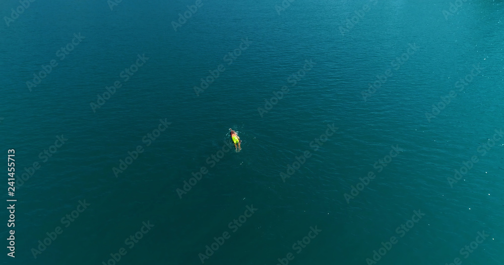 swimmer in a lake in aerial view