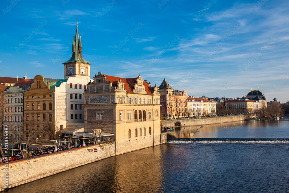 Golden light over the beautiful old town of Prague city during sunset at early spring seen from Charles Bridge
