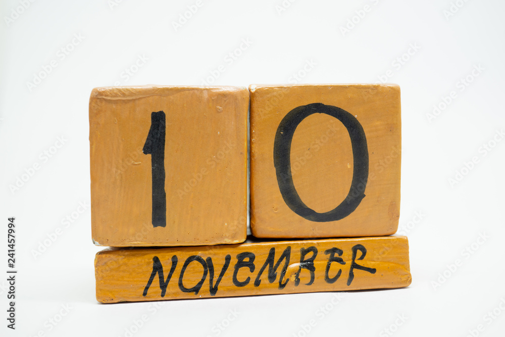 november 10th. Day 10 of month, handmade wood calendar isolated on white background. autumn month, day of the year concept november 10th. Day 10 of month, handmade wood calendar isolated on white background. autumn month, day of the year concept
