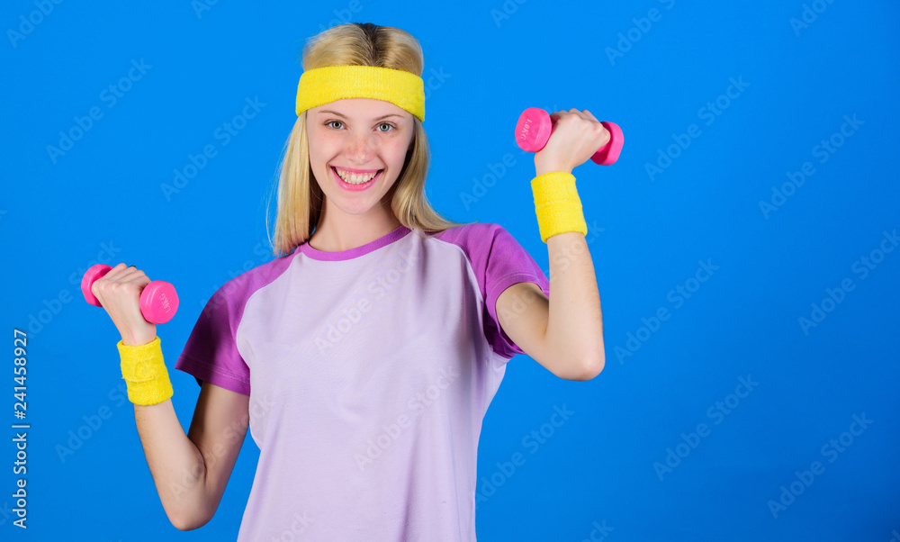 Girl exercising with dumbbell. Workout with dumbbell. Beginner dumbbell exercises. Ultimate upper body workout for women. Fitness instructor hold little dumbbell blue background. Fitness concept Girl exercising with dumbbell. Workout with dumbbell. Beginner dumbbell exercises. Ultimate upper body workout for women. Fitness instructor hold little dumbbell blue background. Fitness concept