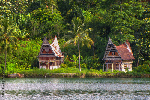 Houses on the shore of Samosir island in the middle of the volcanic lake Toba, Sumatra, Indonesia