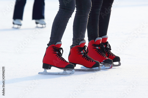 Women's feet skating on the ice rink