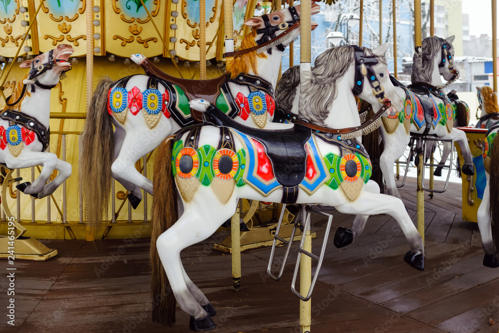 Carousel with rocking horses in the park. Children's carousel is closed for the winter season.