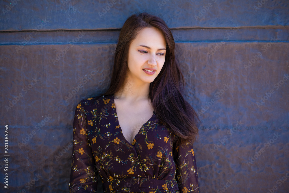 Fototapeta premium Beautiful brunette woman in sexy brown dress
