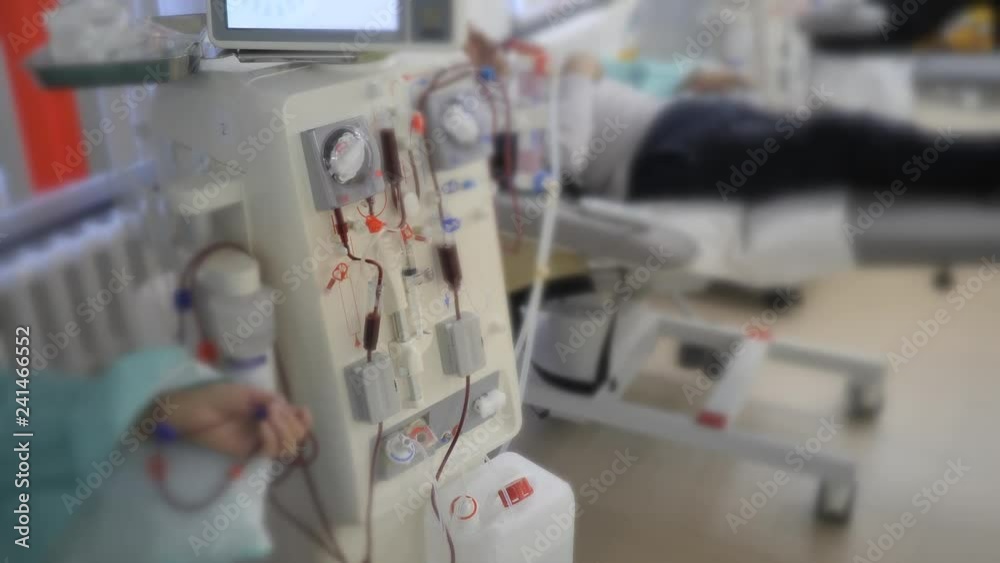 Hemodialysis. Machine artificial kidney. The hand of the patient is connected to the blood purification apparatus. Blood is pumped through transparent tubes by pumps. Hemodialysis. Machine artificial kidney. The hand of the patient is connected to the blood purification apparatus. Blood is pumped through transparent tubes by pumps.
