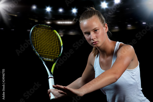 Beautiful girl tennis player with a racket on dark background with lights