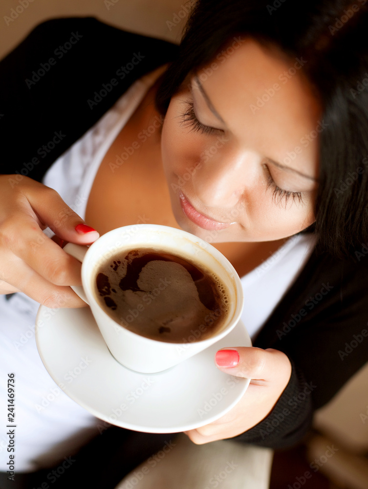 young woman sitting in a cafe drinking coffee young woman sitting in a cafe drinking coffee