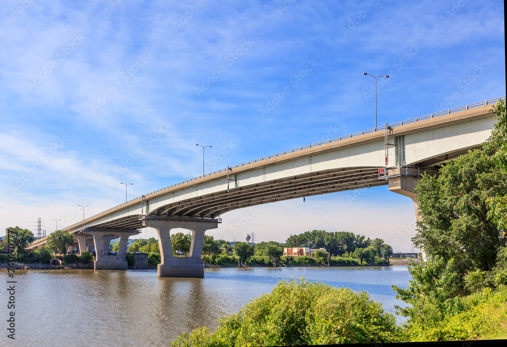 Concrete bridge spanning over the Illinois River by Peoria, showing the shoreline and sky. Concrete bridge spanning over the Illinois River by Peoria, showing the shoreline and sky.