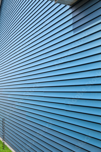 Blue vinyl siding on a home with perspective view