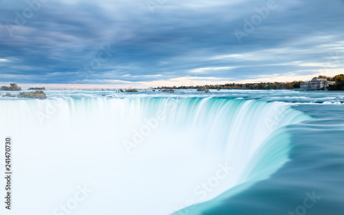The view across the Horseshoe Falls at dusk, a part of the Niagara Falls, viewed from the Canadian side.  The falls straddle the border between America and Canada. © ATGImages
