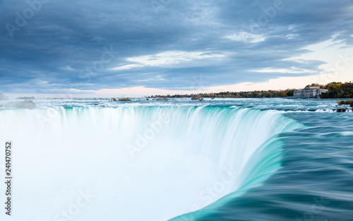 The view across the Horseshoe Falls at dusk, a part of the Niagara Falls, viewed from the Canadian side.  The falls straddle the border between America and Canada. © ATGImages