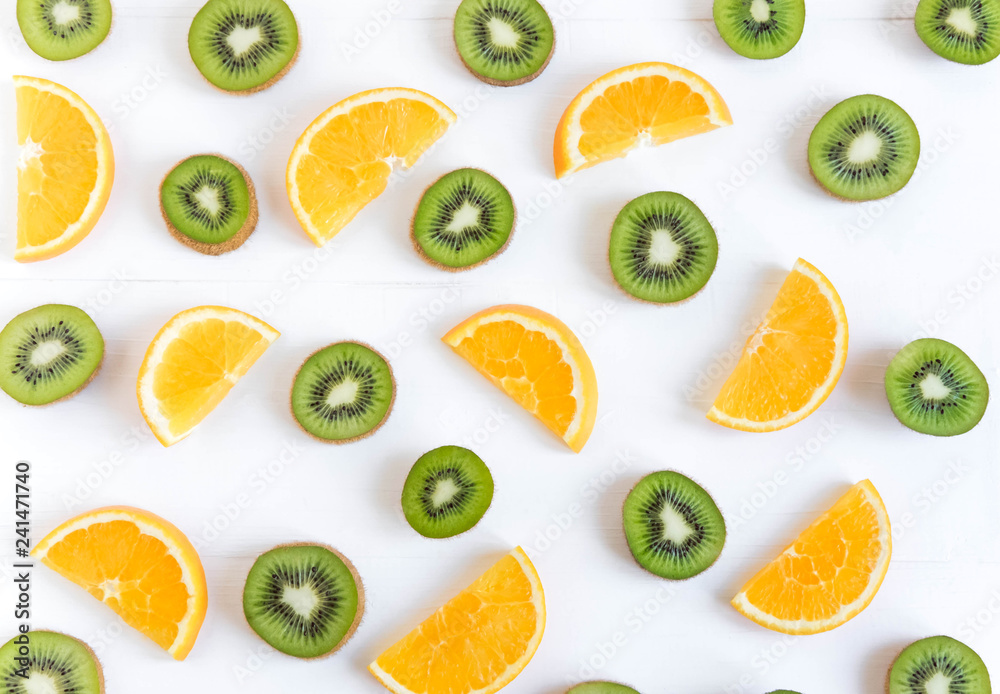Pattern with oranges and kiwi slices on a white wooden background. The basis for the booklet, the background for the banner. Basis for design with tropical fruits