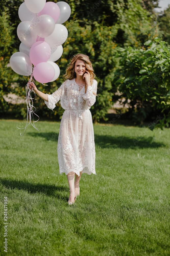 Woman holding balloon on nature background.