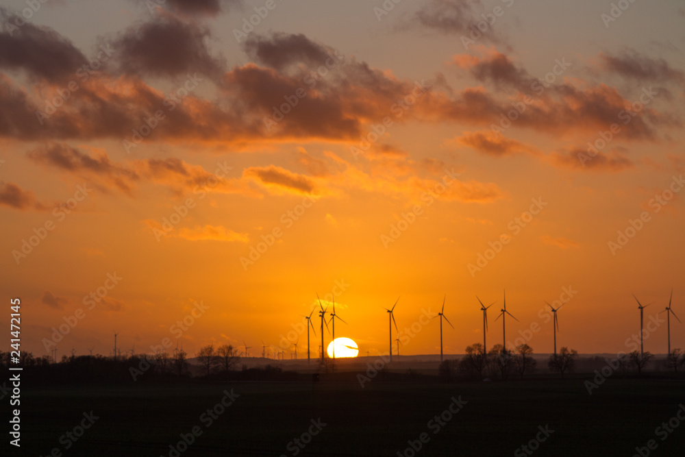 Scenic sunset behind a wind farm