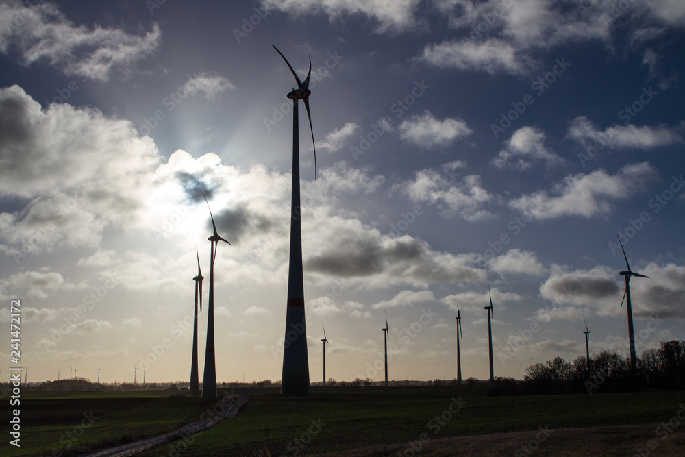 wind turbines with cloudy sky in the background