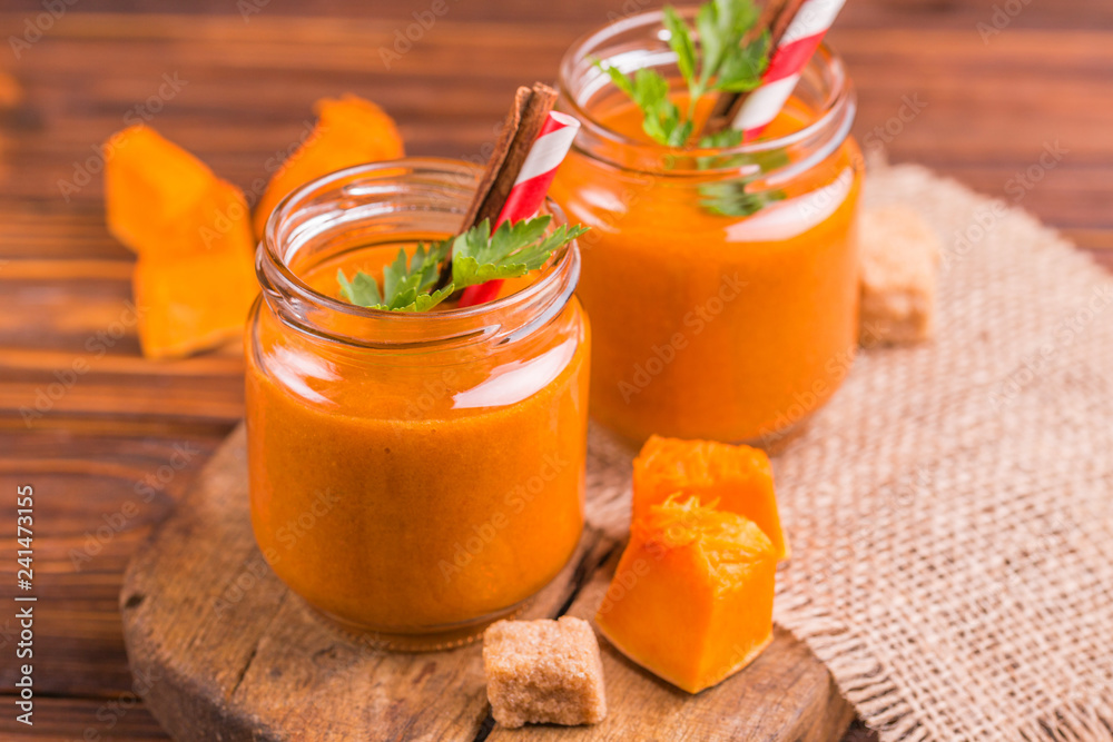 Fresh pumpkin smoothie in glass jar with parsley Fresh pumpkin smoothie in glass jar with parsley