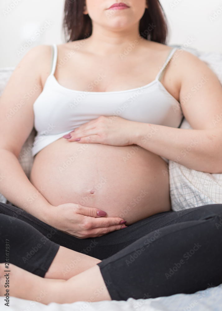 Pregnant woman with hands on her belly Pregnant woman with hands on her belly