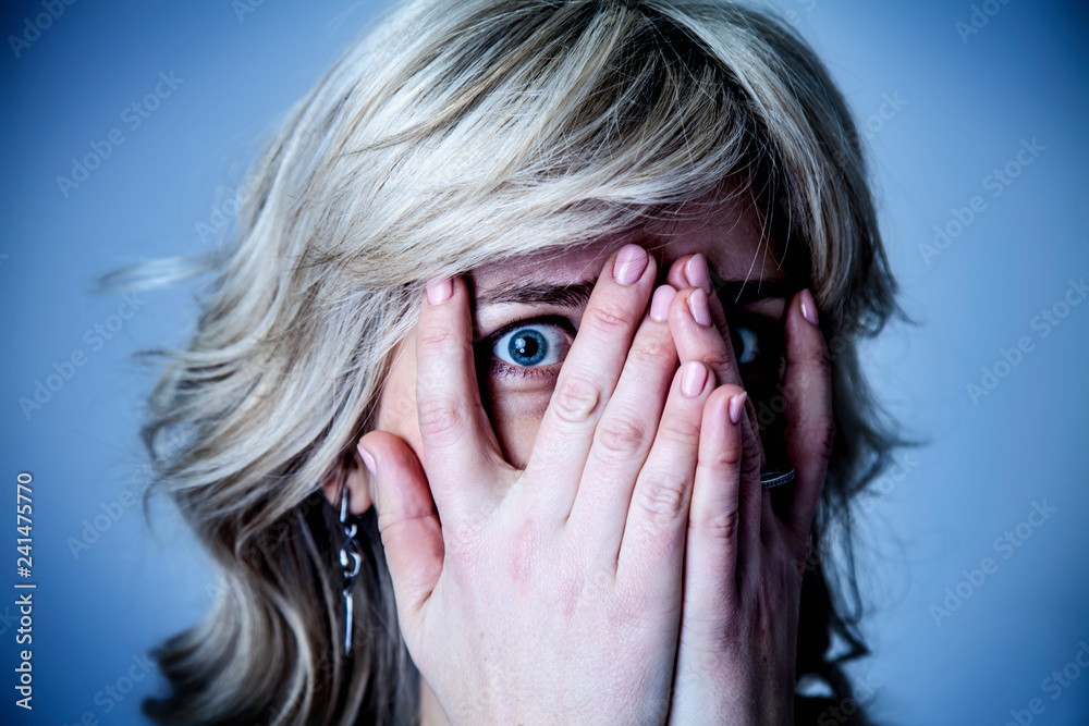 Fear concept. Portrait of a scared woma. Gesture, body language, psychology concept. Fear concept. Portrait of a scared woma. Gesture, body language, psychology concept.