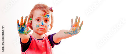 Cute little child girl with colorful painted hands. Portrait.