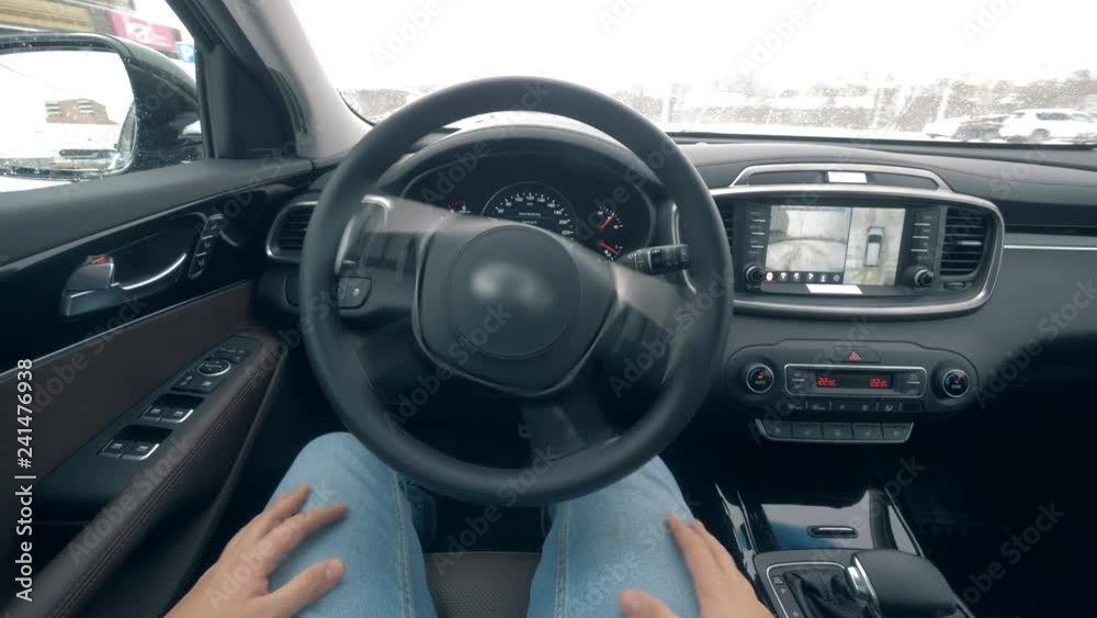 One man sits in a car while it is self-driving, close up. One man sits in a car while it is self-driving, close up.