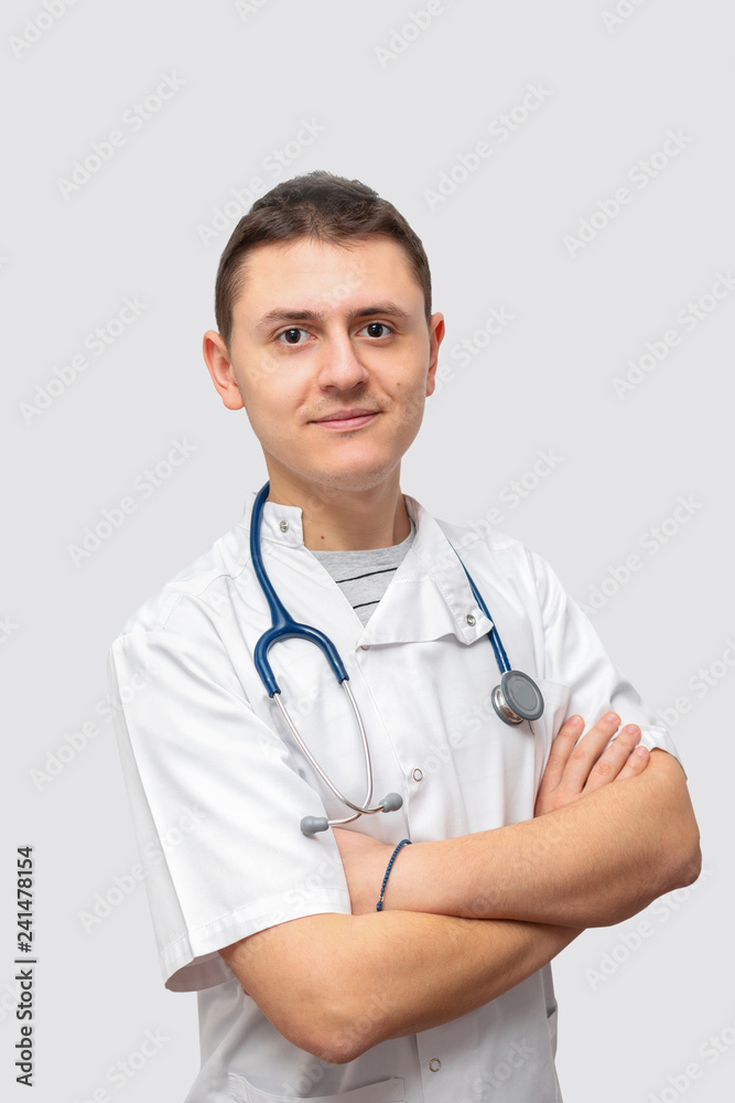 Portrait of smiling young male doctor in uniform Portrait of smiling young male doctor in uniform