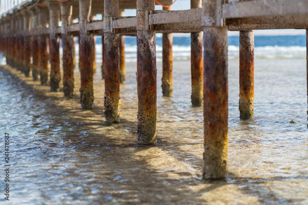 Old weathered wooden poles on a pier