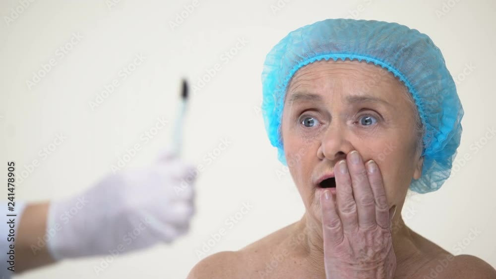 Aging lady afraid of hand with lancet, negative attitude to surgery treatment Aging lady afraid of hand with lancet, negative attitude to surgery treatment