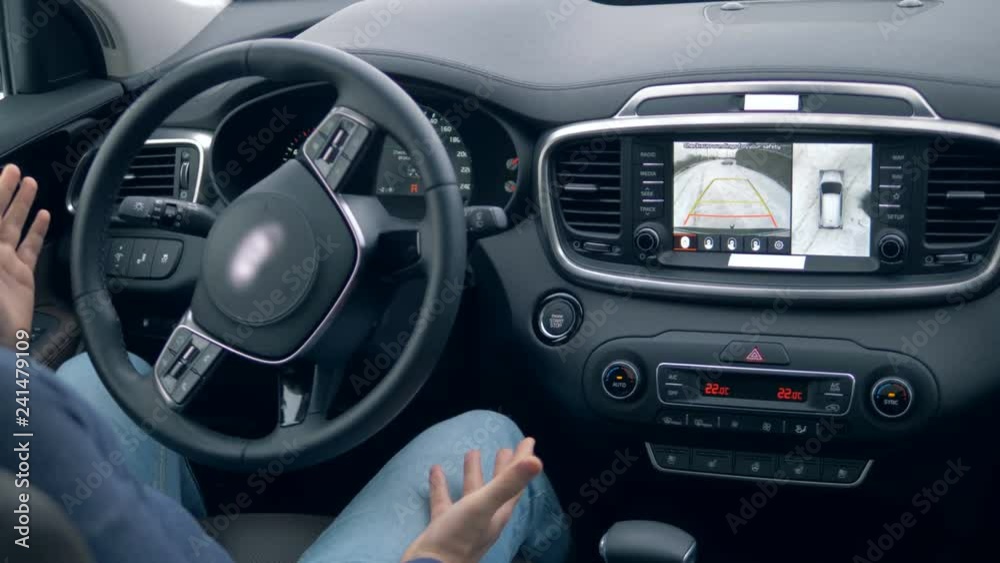 Car on autopilot on a parking lot. Futuristic car driving by itself. Car on autopilot on a parking lot. Futuristic car driving by itself.