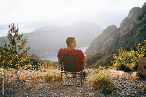 Man relaxing outdoor sitting on chair Travel Lifestyle concept 