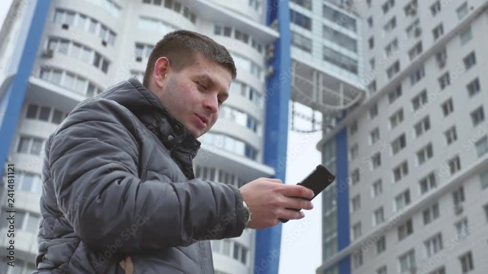 Urban businessman talking on smartphone on the street, businessman thinks. Urban businessman talking on smartphone on the street, businessman thinks.