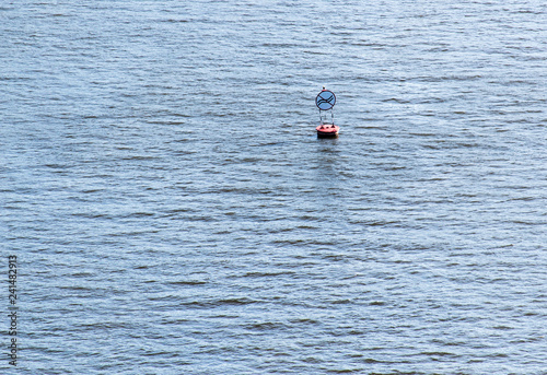 the sign "do not create excitement" on the buoy on the river